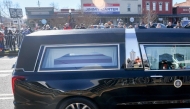 The hearse carrying President Jimmy Carter's flag draped casket passes near the main street of Carter's hometown on January 04, 2025, in Plains, Georgia. (Photo by JOE RAEDLE / GETTY IMAGES NORTH AMERICA / Getty Images via AFP)