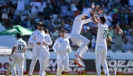 South Africa's Marco Jansen (R) celebrates with South Africa's Tristan Stubbs (2nd R) after the dismissal of Pakistan's Kamran Ghulam (L) during the second day of the second international Test cricket match between South Africa and Pakistan at Newlands stadium in Cape Town on January 4, 2025. (Photo by Rodger Bosch / AFP)
