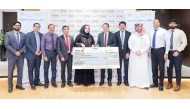 Luly Hypermarket and Qatar Cancer Society officials during the cheque handover ceremony.