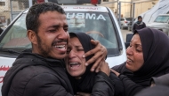 A woman mourns her relatives who were killed by Israeli bombardment outside the Aqsa Martyrs hospital in Deir el-Balah in the central Gaza Strip on January 5, 2025. Photo by Eyad BABA / AFP.
