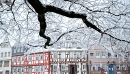 A person walks on a snow-covered street after snowfall in Frankfurt am Main, western Germany, on December 29, 2024. Photo by Kirill KUDRYAVTSEV / AFP.
