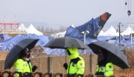 Tarpaulin covers shroud the wreckage of the Jeju Air Boeing 737-800 aircraft, which on December 29 crashed and burst into flames at Muan International Airport in Muan, some 288 kilometres southwest of Seoul, on January 5, 2025. Photo by YONHAP / AFP