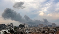 Smoke plumes billow during Israeli bombardment in the Saraya area in al-Rimal in central Gaza City on January 4, 2025. (Photo by Omar AL-QATTAA / AFP)
