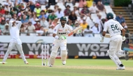 Pakistan's Shan Masood (C) and Pakistan's Babar Azam (R) run between the wickets during the third day of the second international Test cricket match between South Africa and Pakistan at Newlands stadium in Cape Town on January 5, 2025. (Photo by Rodger Bosch / AFP)
