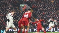 Manchester United's Ivorian midfielder #16 Amad Diallo (R) shoots to score their second goal during the English Premier League football match between Liverpool and Manchester United at Anfield in Liverpool, north west England on January 5, 2025. (Photo by Darren Staples / AFP) 