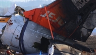 Investigators and emergency response personnel work at the site where a Jeju Air Boeing 737-800 aircraft crashed and burst into flames at Muan International Airport in Muan, some 288 kilometres southwest of Seoul on January 4, 2025. Photo by YONHAP / AFP