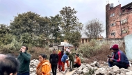 People gather in an open area following earthquake tremors in Kathmandu, in the early hours on January 7, 2025. (Photo by Sunil Sharma / AFP)