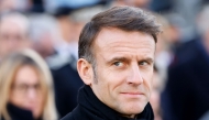 France's President Emmanuel Macron looks on as he takes part in a wreath-laying ceremony to pay tribute to Ahmed Merabet, a Muslim police officer guarding the offices who was executed at point-blank range, as part of marking 10 years since an attack on the Charlie Hebdo satirical newspaper, on January 7, 2025.  (Photo by Ludovic Marin  / AFP) 