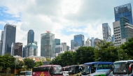 Tourist buses are parked at an open carpark near the Chinatown district in Singapore on January 7, 2025. (Photo by Roslan RAHMAN and ROSLAN RAHMAN / AFP)