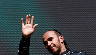 Mercedes' British driver Lewis Hamilton waves as he arrives for the podium ceremony after the Formula One Belgian Grand Prix at the Spa-Francorchamps Circuit in Spa on July 28, 2024. (Photo by SIMON WOHLFAHRT / AFP)

