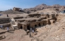 Visitors walk around a dig showcasing the tomb of an overseer of the palace of Queen Teti Sheri, during a media event to announce new discoveries by an Egyptian archaeological mission in Deir El-Bahari on the Nile's west bank in Luxor on January 8, 2025. (Photo by Khaled DESOUKI / AFP)