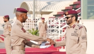 Commander of the Amiri Guard Lt. Gen. Staff Hazza bin Khalil Al Shahwani honouring one of the top graduating students at the event.