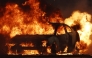 A vehicle burns during the Eaton Fire on January 8, 2025 in Altadena, California. Over 1,000 structures have burned, with two people dead, in wildfires fueled by intense Santa Ana Winds across L.A. County. Mario Tama/Getty Images/AFP (Photo by MARIO TAMA / GETTY IMAGES NORTH AMERICA / Getty Images via AFP)