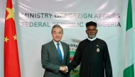 Chinese Foreign Minister Wang Yi (L) shakes hands with Nigeria's Foreign Affairs Minister Yusuf Tuggar (R) during Minister Wang's diplomatic visit to Abuja on January 9, 2025. (Photo by Kola Sulaimon / AFP)
