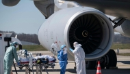 File: Medical staff embark a patient infected with the COVID-19 onboard a French air force medicalised Airbus A330 Phenix aircraft at the Bale-Mulhouse airport in France on March 31, 2020. (Photo by SEBASTIEN BOZON / AFP)