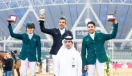 Al Shaqab Corporate Services Director Hamza Al Kuwari poses for a photo with the podium winners of the The World Cup qualifying CSI4*-W - Faults & Time - 1.45m (LR) class Mariano Martinez Bastida (top centre), Abdullah Alsharbatly (left) and Abdulrahman Alrajhi.