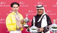 QREC Racing Manager Abdulla Rashid Al Kubaisi hands trophy to jockey Jefferson Smith. PICS: Juhaim/QREC