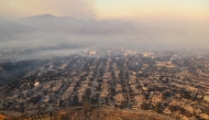 In this aerial view taken from a helicopter, burned homes are seen from above during the Palisades fire near the Pacific Palisades neighborhood of Los Angeles, California on January 9, 2025. Photo by JOSH EDELSON / AFP