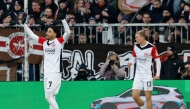 Frankfurt's Egyptian forward #07 Omar Marmoush (L) celebrates scoring during the German first division Bundesliga football match between St Pauli and Eintracht Frankfurt in Hamburg on January 11, 2025. (Photo by Axel Heimken / AFP)