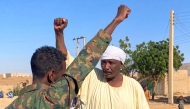 Sudanese people lift their fists as they celebrate on a street in Meroe in the country's Northern State on January 11, 2025, after the army announced entering key Al-Jazira state capital Wad Madani, held by the paramilitary Rapid Support Forces (RSF). (Photo by AFP)
