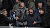 German football trainer and global head of Football at Red Bull, Jurgen Klopp (front 2ndR) shakes hands with French journalist and writer Michel Denisot (L) next to representative of the Agache family holding company Antoine Arnault at the end of the French Digue 2 football match between Paris football Club (PFC) and Amiens at Stade Charley in Paris, on January 11, 2025. (Photo by FRANCK FIFE / AFP)
