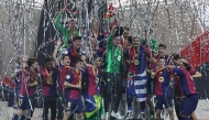 Barcelona's players celebrate with the trophy after winning the Spanish Super Cup final football match between Real Madrid and Barcelona at the King Abdullah Sport City in Jeddah on January 12, 2025. (Photo by FADEL SENNA / AFP)
