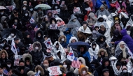 Supporters of impeached South Korean president Yoon Suk Yeol attend a rally near his residence in Seoul on January 13, 2025. (Photo by YASUYOSHI CHIBA / AFP)