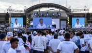 Members of the influential sect Iglesia ni Cristo (Church of Christ) watch Philippine lawmaker Rodante Marcoleta speak as they attend a rally to oppose calls to unseat Vice-President Sara Duterte in Manila on January 13, 2025. (Photo by JAM STA ROSA / AFP)