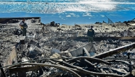 A cadaver dog, from the Los Angeles County Sheriff, sniffs through the rubble of beachfront properties destroyed by the Palisades Fire along Pacific Coast Highway in Malibu, California, on January 12, 2025. Photo by Frederic J. BROWN / AFP