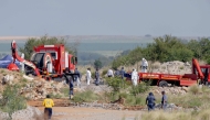 Rescuers and South African Police Service (SAPS) officers carry remains in blue body bags during a rescue operation to retrieve illegal miners from an abandoned gold shaft in Stilfontein on January 13, 2025.Photo by Christian Velcich / AFP