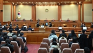 (L to R) Constitutional Court Judges Chung Kye-sun, Kim Bok-hyeong, Jung Jung-mi, Lee Mi-son, acting head of the Constitutional Court Moon Hyung-bae, Kim Hyung-du, Cheong Hyung-sik and Cho Han-chang attend the first formal hearing of the impeachment trial of suspended South Korean President Yoon Suk Yeol at the Constitutional Court in Seoul on January 14, 2025. Photo by KIM Min-Hee / POOL / AFP