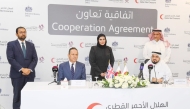 Minister of State for International Cooperation H E Maryam bint Ali bin Nasser Al Misnad (centre, back); UK Ambassador to Qatar H E Neerav Patel (left, back), and President of QRCS Yousef bin Ali Al Khater (right, back) at the agreement signing ceremony yesterday. 