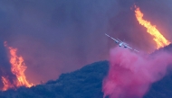 A firefighting aircraft drops the fire retardant Phos-Chek as the Palisades Fire burns amid a powerful windstorm on January 7, 2025 in Pacific Palisades, California. Mario Tama/Getty Images/AFP 