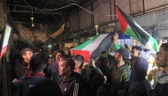 People celebrate along a street at Deir el-Balah in the central Gaza Strip on January 15, 2025, as news spread that a ceasefire and hostage release deal had been reached between Israel and Hamas. (Photo by Eyad Baba / AFP)