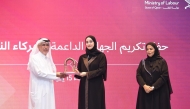 Assistant Undersecretary of the Ministry of Labour H E Sheikha Najwa bint Abdulrahman Al Thani honouring Deputy CEO of Dar Al Sharq and Editor-in-Chief of Al Sharq, Jaber Al Harami, during the ceremony in Doha yesterday.