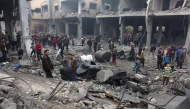 People check the rubble of buildings hit in Israeli strikes the previous night in Jabalia in the northern Gaza Strip, on January 16, 2025. (Photo by Omar Al-Qattaa / AFP)