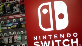 The Nintendo Switch logo is seen beside products for sale at the gaming section of a shop in Tokyo on January 16, 2025. Photo by Philip FONG / AFP