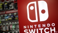 The Nintendo Switch logo is seen beside products for sale at the gaming section of a shop in Tokyo on January 16, 2025. Photo by Philip FONG / AFP