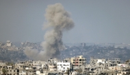 This picture taken from the Israeli side of the border with the Gaza Strip shows smoke plumes rising from explosions above destroyed buildings in the northern Gaza Strip on January 16, 2025, following the announcement of a ceasefire. Photo by Menahem KAHANA / AFP.