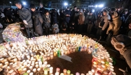 People take part in an early morning ceremony to remember the victims on the 30th anniversary of the 