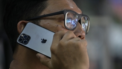 A man uses an Apple iPhone in Jakarta on January 8, 2025. (Photo by BAY ISMOYO / AFP)
