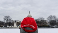 A man wearing a Trump hat looks at the US Capitol on January 17, 2025, in Washington, DC. (Photo by Matthew Hatcher / AFP)
 