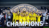 Al Wasl's players and officials celebrate with the Super Shield. 