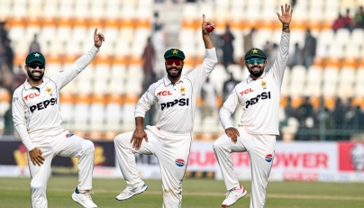 Pakistan's Sajid Khan (C) celebrates with Mohammad Rizwan (L) and Babar Azam after taking a five-wicket haul at the Multan Cricket Stadium in Multan on January 19, 2025. (Photo by Aamir Qureshi / AFP)