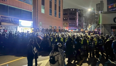 Police stand guard on a street near the Seoul Western District Court in Seoul, early on January 19, 2025, after hundreds of pro-Yoon protesters smashed windows and broke down doors to enter the court following the extension of the detention of impeached South Korea President Yoon Suk Yeol. Photo by Jin-kyu Kang / AFP