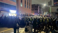 Police stand guard on a street near the Seoul Western District Court in Seoul, early on January 19, 2025, after hundreds of pro-Yoon protesters smashed windows and broke down doors to enter the court following the extension of the detention of impeached South Korea President Yoon Suk Yeol. Photo by Jin-kyu Kang / AFP