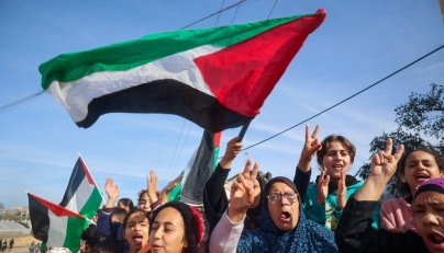 Displaced Palestinians wave national flags as they return to Rafah, in the southern Gaza Strip, on January 19, 2025. (Photo by Eyad Baba / AFP)