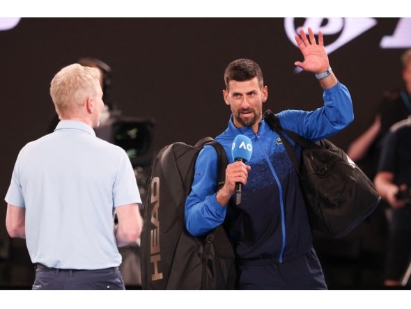 Serbia's Novak Djokovic (R) speaks into the microphone on court after winning his men's singles match against Czech Republic's Jiri Lehecka in Melbourne on January 19, 2025. (Photo by David Gray / AFP)