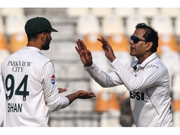 Pakistan's Noman Ali (R) celebrates with his captain Shan Masood after taking the wicket of West Indies' Kevin Sinclair during the second day of the first Test cricket match between Pakistan and West Indies at the Multan Cricket Stadium in Multan on January 18, 2025. (Photo by Aamir QURESHI / AFP)
