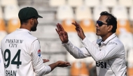 Pakistan's Noman Ali (R) celebrates with his captain Shan Masood after taking the wicket of West Indies' Kevin Sinclair during the second day of the first Test cricket match between Pakistan and West Indies at the Multan Cricket Stadium in Multan on January 18, 2025. (Photo by Aamir QURESHI / AFP)
